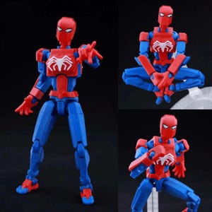 May include: A posable action figure featuring a red and blue color scheme with a white spider emblem on the chest. The figure is shown in three different poses, including standing with an outstretched hand, sitting cross-legged, and crouching.