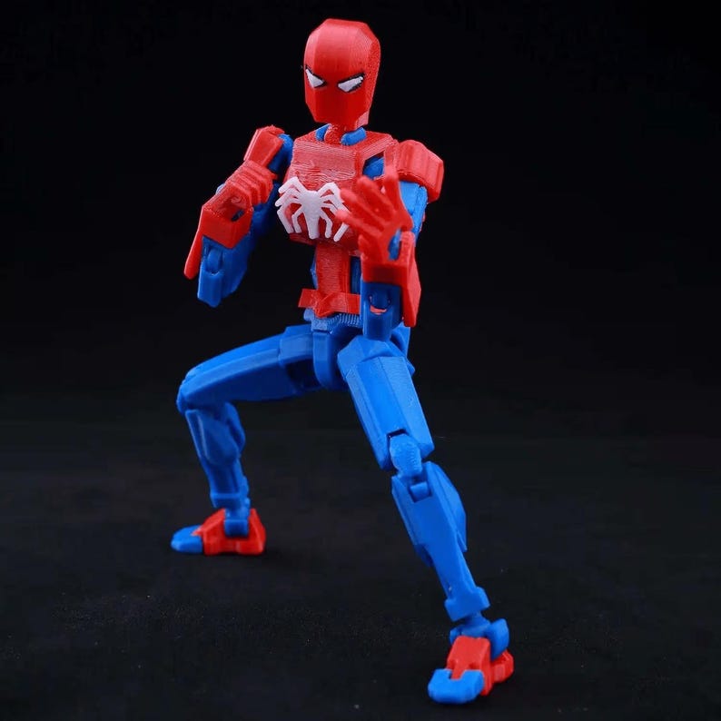 May include: A posable action figure of a superhero character with a red and blue color scheme. The figure features a white spider emblem on the chest, a red mask with white eye lenses, and articulated joints in a dynamic, ready-to-fight stance.