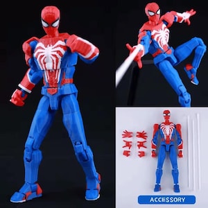 May include: A posable action figure of a superhero character featuring a red and blue suit with a prominent white spider emblem on the chest. The set includes the figure, multiple interchangeable hand attachments, and long white web-like accessories.