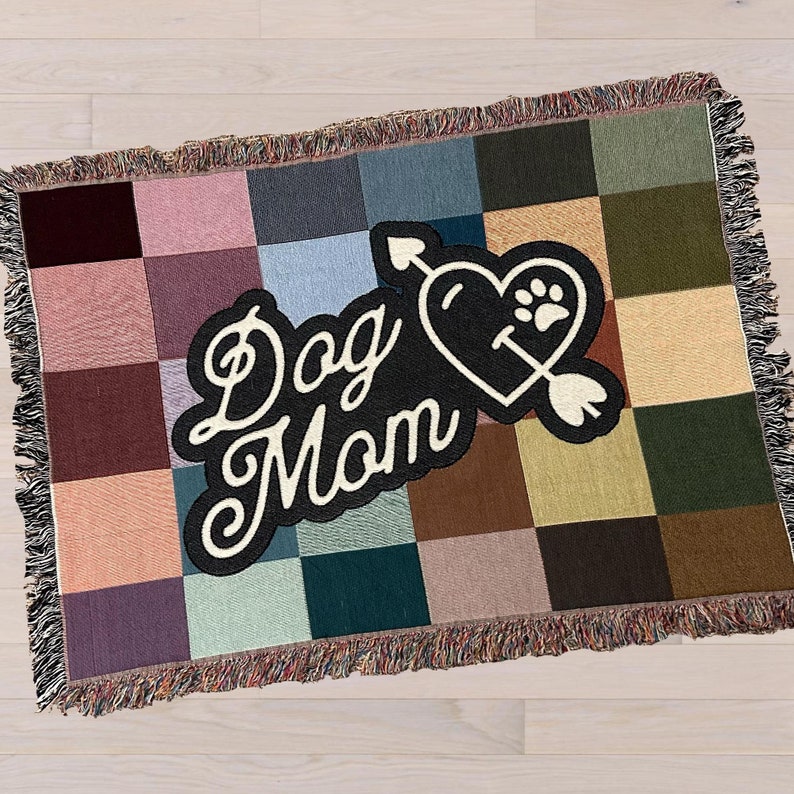 Front of colorful woven cotton Dog Mom throw blanket featuring retro checkerboard design.