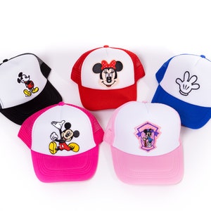 May include: Five different children's baseball caps with various Mickey Mouse designs. The caps are black, red, blue, pink, and white with black mesh.
