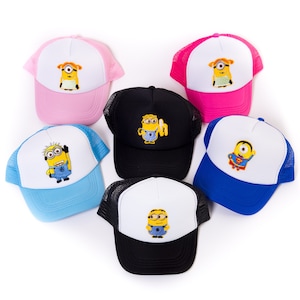 May include: Six different colorful trucker hats with a variety of embroidered images of the Minions from the Despicable Me movies. The hats are black, pink, blue, and white.
