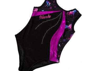 May include: Black gymnastics leotard with a purple stripe and unicorn print. The leotard has the name "Nicole" in pink script and a dotted design. The sleeves and back feature a starry night sky with unicorns.