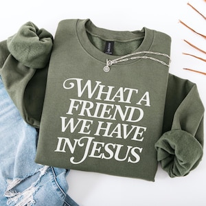 May include: A green sweatshirt with the text "What a friend we have in Jesus" printed in white.