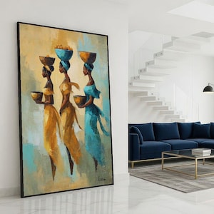 May include: An abstract painting of three women in long dresses, each with a bowl. The women are in yellow and blue, with bowls on their heads and in their hands. The artwork is framed in black.