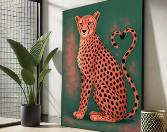 May include: A framed art print featuring a cheetah with orange fur and black spots, set against a green and red background. The cheetah's tail forms a heart shape. The artwork is displayed indoors near a potted plant and a decorative gold metal wastebasket.