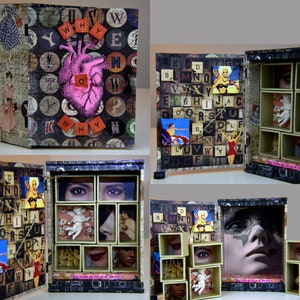 May include: A wooden box with a hinged front and a series of small drawers. The front of the box is covered in a collage of letters, a heart, and other images. The drawers are open and reveal more collages, including a woman's face, a heart, and a cherub.