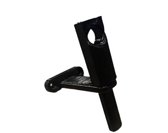 May include: A black 3D printed wall mount with a circular opening for a phone or other device.