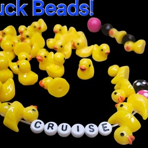 May include: Yellow rubber ducky beads with black and pink polka dot beads and white letter beads spelling "CRUISE".