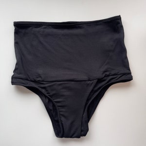 May include: Black high-waisted underwear with a smooth, seamless design.