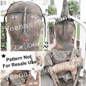 May include: A handmade witch doll pattern with a black and white striped dress and a black cat. The doll is sitting on a white chair. The pattern is called "Dorothy Witch Doll Pattern" and is by Veenas Mercantile. The text "Pattern Not For Resale Use" is also included.