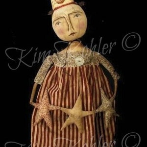 May include: A handmade doll wearing a red and white striped dress and a paper cone hat with the letters "USA" on it. The doll is holding two stars in each hand. The doll is a whimsical and patriotic Americana Party Girl.
