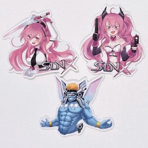 May include: Three anime-style stickers featuring a pink-haired female character with a sword, a pink-haired female character with guns, and a blue-skinned male character with wings. Each sticker has the text "SDVX" on it.