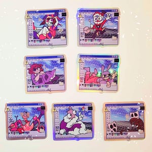 May include: Six holographic stickers featuring cartoon characters in a Windows 95 Paint program interface. The characters are a jester, a clown, a bunny, a creature with a crown, a creature with a crown and a creature with a crown.