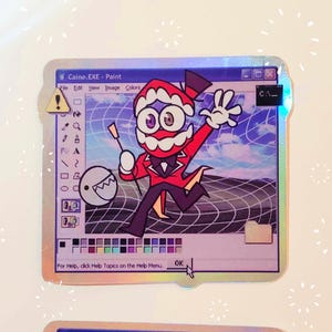 May include: A digital art sticker featuring a cartoon character with a red and black outfit, a top hat, and a large mouth. The character is standing in front of a blue and white background with a grid pattern. The sticker has a holographic finish and the text "Caine.EXE - Paint" is visible at the top.