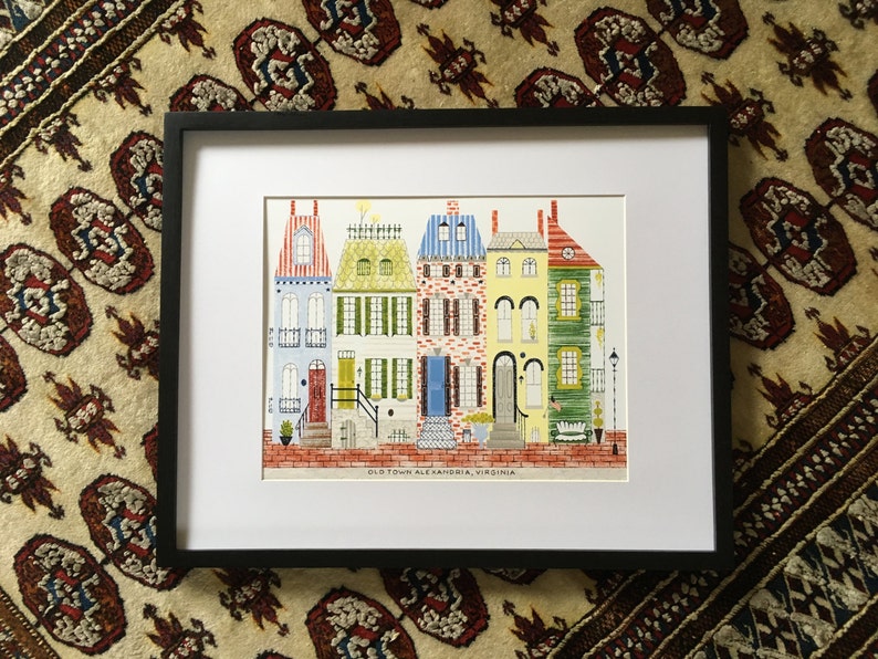 May include: A framed illustration of five colorful row houses with red brick sidewalks and the text "Old Town Alexandria, Virginia".