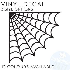 May include: Black vinyl decal featuring a spider web corner design. The text "VINYL DECAL" is at the top, with "3 SIZE OPTIONS" below it. The text "12 COLOURS AVAILABLE" is at the bottom.