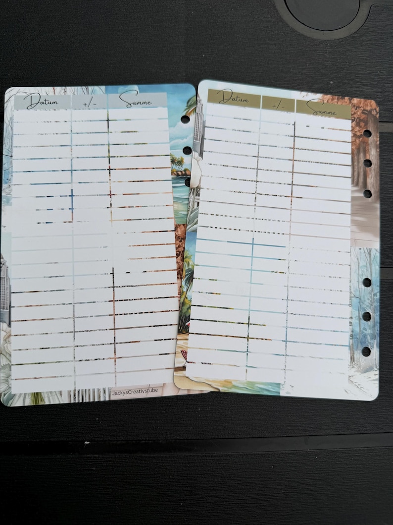 May include: Two planner inserts featuring a white grid with columns labeled Datum, +/-, and Summe. The pages have a decorative border with nature-themed illustrations and punched holes on the side. The text JackysCreativstube is printed at the bottom.