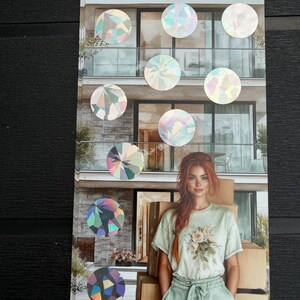 May include: A rectangular sticker sheet featuring a printed image of a person with long red hair wearing a light green floral t-shirt and matching pants, standing in front of a modern building with cardboard boxes, overlaid with several holographic circles.