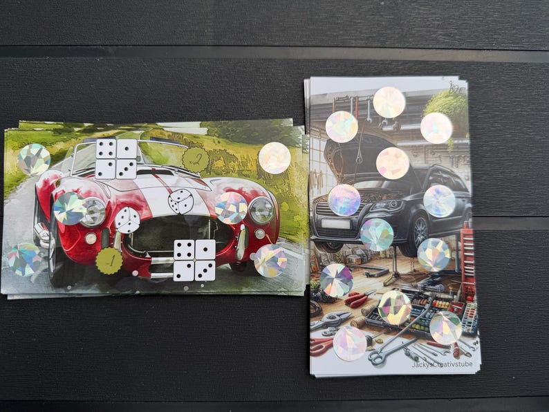 May include: Two rectangular cards featuring automotive imagery. The left card shows a red sports car with white stripes and dice graphics. The right card depicts a black car in a garage with tools and holographic circular stickers throughout both.