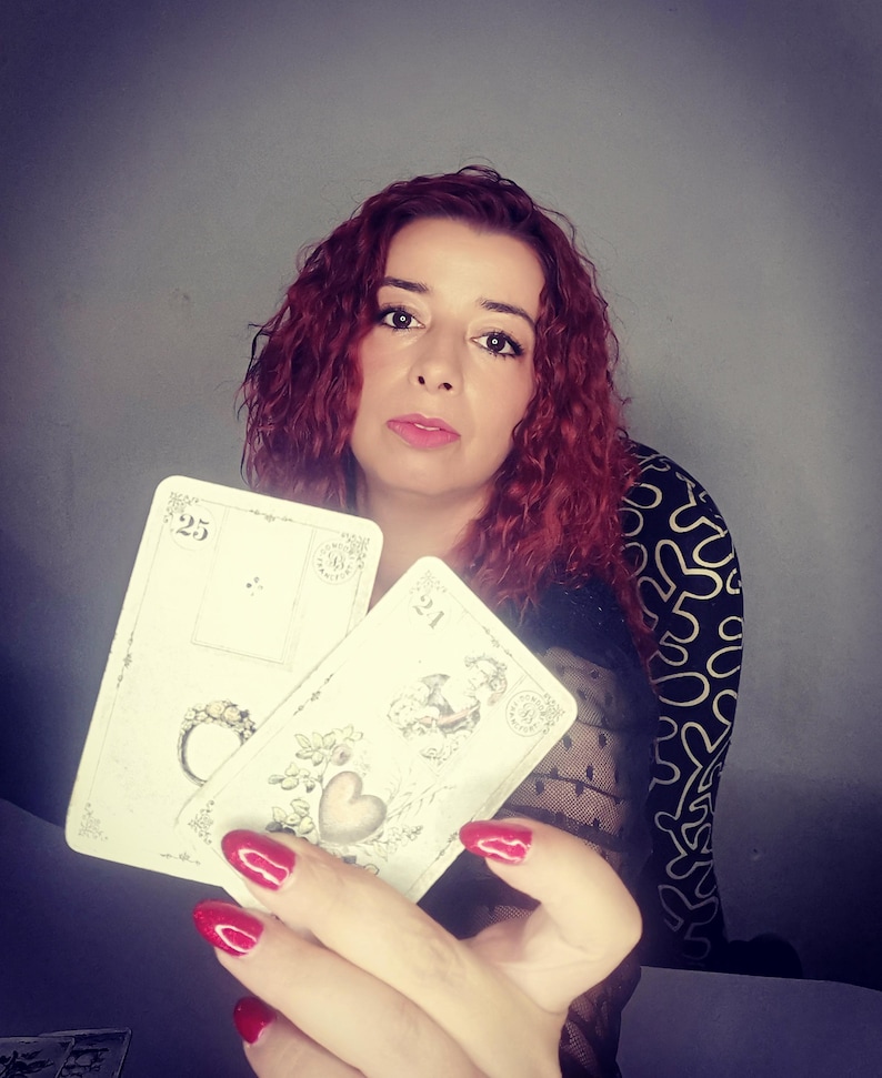 Psychic reader holding Lenormand cards featuring symbols such as the Ring and the Heart, representing love, commitment, and emotional guidance. This image illustrates a professional lenormand cards reading and psychic reading session focused on relationships, clarity, and intuitive insights, offering accurate future reading through traditional Lenormand divination cards.
