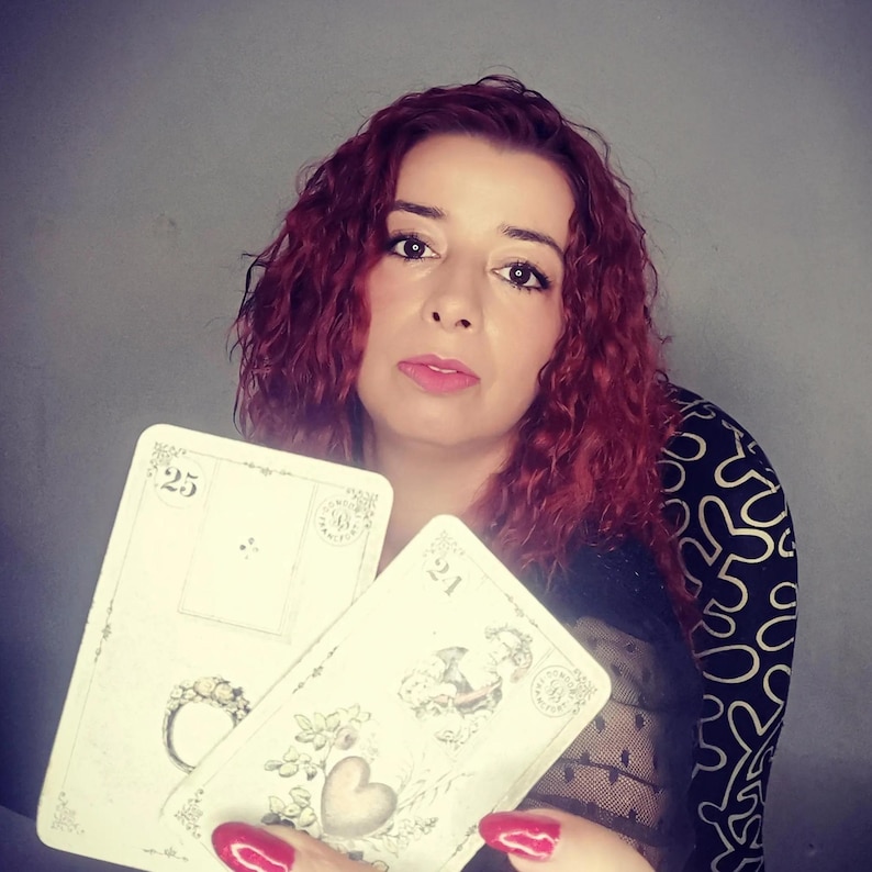 Psychic reader holding Lenormand cards featuring symbols such as the Ring and the Heart, representing love, commitment, and emotional guidance. This image illustrates a professional lenormand cards reading and psychic reading session focused on relationships, clarity, and intuitive insights, offering accurate future reading through traditional Lenormand divination cards.