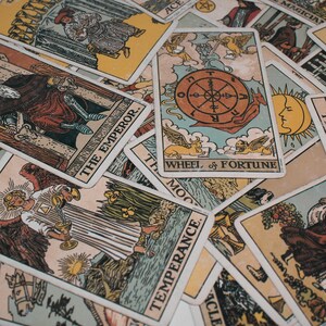Close-up of a classic tarot reading spread featuring major arcana cards such as the Wheel of Fortune, Temperance, The Emperor, and The Sun. This detailed tarot card layout symbolizes guidance, destiny, and balance, representing the work of a psychic medium offering intuitive tarot reading and future reading for insight, clarity, and spiritual direction.