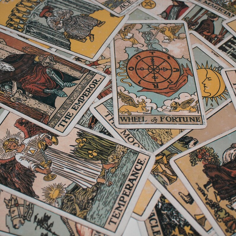 Close-up of a classic tarot reading spread featuring major arcana cards such as the Wheel of Fortune, Temperance, The Emperor, and The Sun. This detailed tarot card layout symbolizes guidance, destiny, and balance, representing the work of a psychic medium offering intuitive tarot reading and future reading for insight, clarity, and spiritual direction.