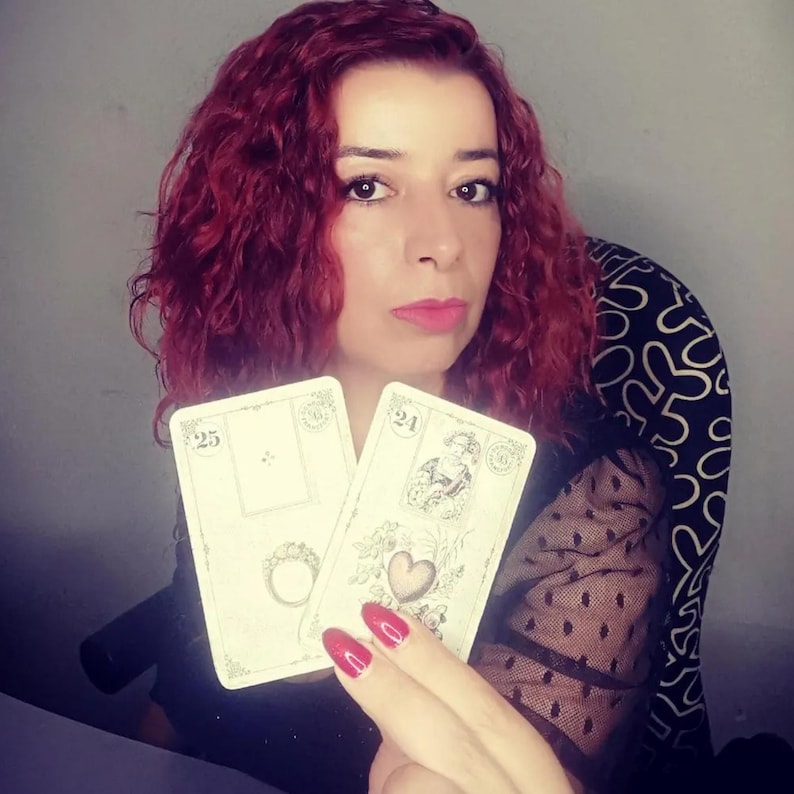 Psychic reader holding Lenormand cards showing the Ring and the Heart, symbolizing love, commitment, and relationship insight. This image represents a professional lenormand cards reading and intuitive psychic reading focused on emotional clarity, personal connections, and accurate future reading through traditional Lenormand divination.