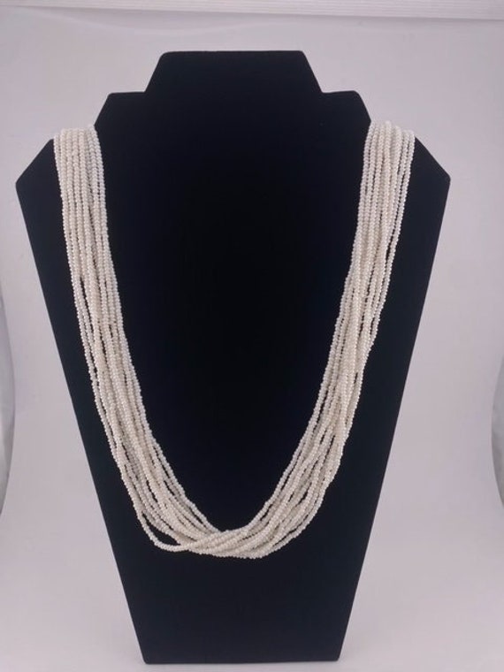 Multi-strand white beaded necklace