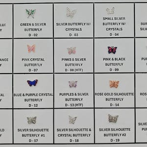 May include: A grid of butterfly-shaped embellishments in various colors and styles. The butterflies include tri-color blue, green and silver, silver with crystals, and burnt orange and silver. Each butterfly is labeled with a description.