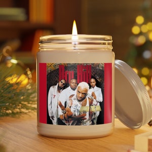 May include: A white candle with a red label featuring a photo of a group of four people. The label says "Dru Hill" and "Super  The  World".