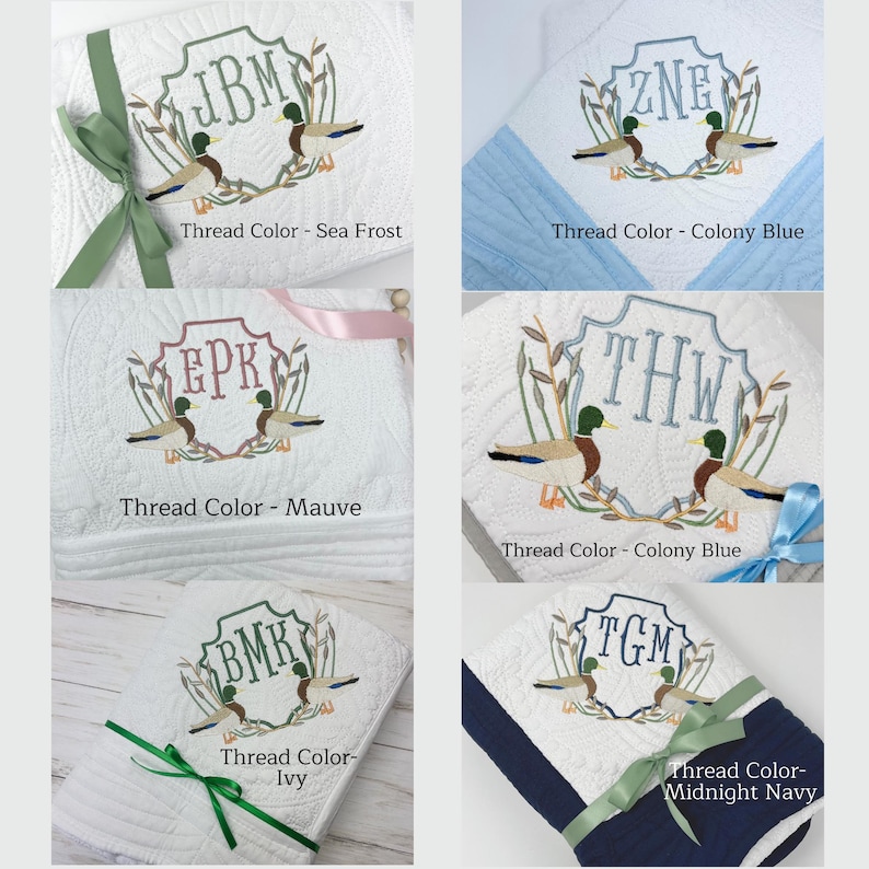 May include: Five embroidered towels with a monogram and two ducks in a wreath design. The towels are in different colors, including white, blue, and navy. The monograms are "JBM", "ZNE", "EPK", "THW", and "TGM". The thread colors are Sea Frost, Colony Blue, Mauve, Colony Blue, Ivy, and Midnight Navy.