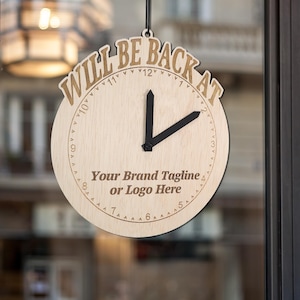 May include: A wooden clock with the text "WILL BE BACK AT" and a space for a brand tagline or logo. The clock hands are set to 3:00.