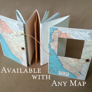 May include: A handmade journal with a map of Peru on the cover. The journal has a brown leather spine and is tied closed with twine. The text "Peru 2014 The Journey Begins Adventure" is printed on the cover. The journal is available with any map.