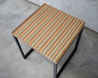 Unique coffee or side table made from recycled skateboards with a striped design