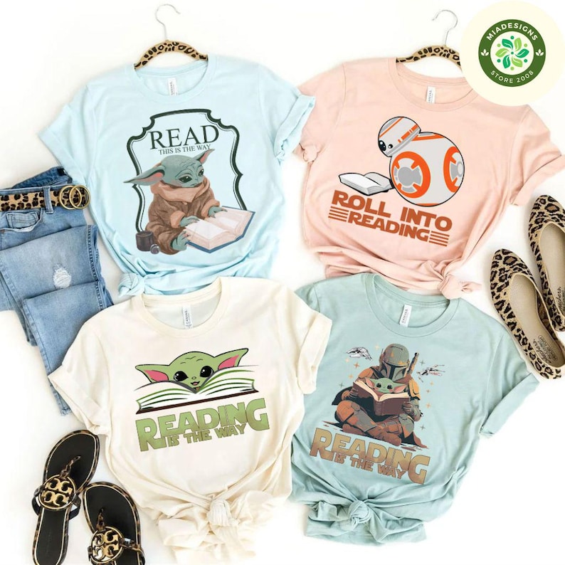 May include: Four different t-shirts featuring a Star Wars theme with the text "Read this is the way", "Roll into reading", "Reading is the way", and "Reading is the way".