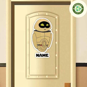 May include: A gold robot character with yellow eyes and a black belt. The robot is on a white background with the word "NAME" printed below it.