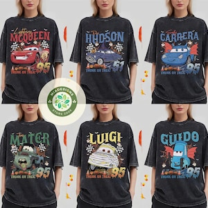 May include: Six dark gray t-shirts featuring Halloween-themed designs of characters from the movie Cars. Each shirt has a different character's name, a number 95, and the phrase "Trunk or Treat".