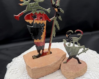 Lazard metal figure sculpture.