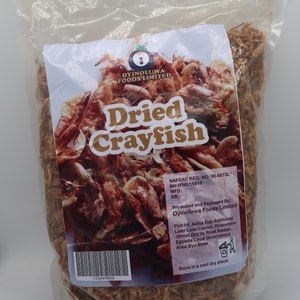 May include: A bag of dried crayfish, labeled "Oyinoluwa Foods Limited Dried Crayfish". The bag includes the NAFDAC registration number, batch number, and manufacturing date. The product is packaged in a clear plastic bag with a white label.