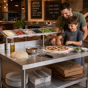 Puede incluir: Una mesa de preparación de pizza de acero inoxidable con riel de ingredientes refrigerado, un bol metálico con salsa, una bola de masa, un cortador de pizza y una pizza siendo preparada. Debajo, platos blancos, paños y cajas de cartón.