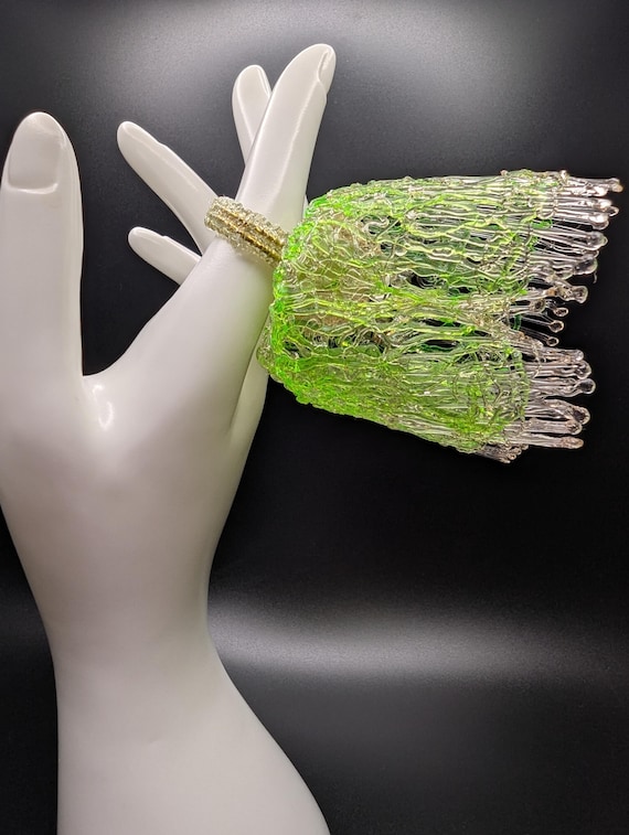 A ring literally printed in 3D with flexible TPU to look like a chunk of neon green glass — genuinely never-seen-it craft-meets-tech jewelry.