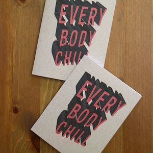 May include: Two brown cards with the text "EVERYBODY CHILL" printed in black and red letters. The letters are in a 3D style.