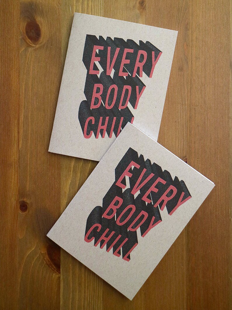 May include: Two brown cards with the text "EVERYBODY CHILL" printed in black and red letters. The letters are in a 3D style.