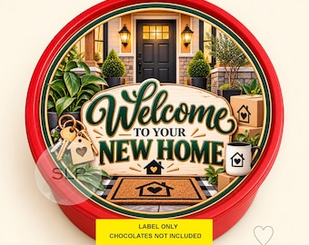 May include: A round red tin featuring a house entrance scene with a welcome mat, keys, and boxes. The text reads Welcome TO YOUR NEW HOME. A yellow label at the bottom states LABEL ONLY CHOCOLATES NOT INCLUDED. The design includes green plants and a mug.