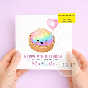 May include: A birthday card with a cartoon dumpling design. The dumpling has a rainbow-colored top and sits in a bamboo steamer. A pink heart balloon with the number 9 floats above. The card says "Happy 9th Birthday to a special granddaughter Matilda."