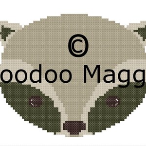 May include: A beige and green pixelated raccoon face with the text "Voodoo Maggie" and a copyright symbol.