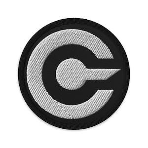 May include: A black and white embroidered patch with a stylized letter C in a circle.