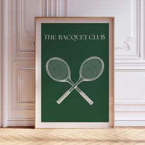 May include: A green poster with white text that reads "THE RACQUET CLUB". Two white tennis rackets are crossed in the center of the poster.